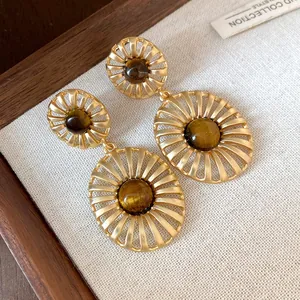Elegant vintage tiger eye stone earrings with an oval hollow gold-plated metal design.