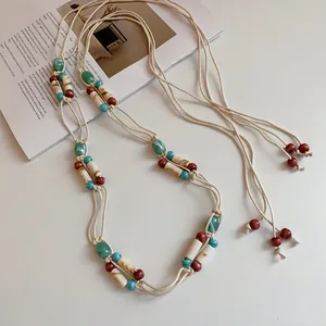 Detailed view of a Bohemian handmade braided waist chain decorated with colorful beads