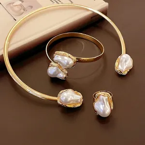 Vintage French jewelry set featuring irregular pearls in gold wrinkled metal finish