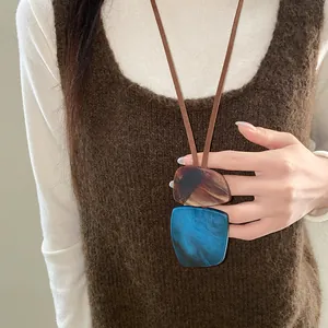 Close-up view of a vintage ethnic style necklace with irregular blue and brown pendants