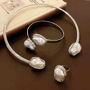 Detailed shot of irregular wrinkled metal and artificial pearl vintage jewelry set