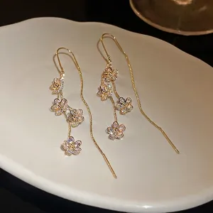 Elegant gold plated flower tassel earrings with sparkling cubic zirconia accents