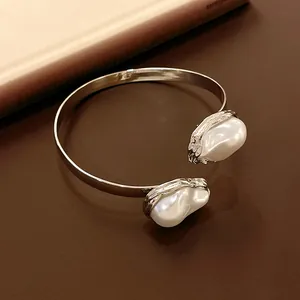 Detailed view of French retro silver collar with irregular baroque faux pearls.