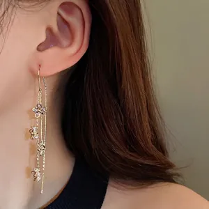 Elegant long tassel earrings with gold plating and sparkling zircon flower motifs.