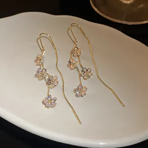 Detailed view of elegant real gold plated zircon flower tassel drop earrings for women.