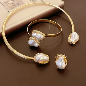 Detailed view of French vintage jewelry set with irregular baroque pearls and gold plating.
