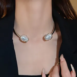 French vintage choker necklace with irregular faux pearls shown on a model in a black blazer.