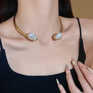 Detail of a French retro gold choker necklace featuring irregular pleated metal and pearls