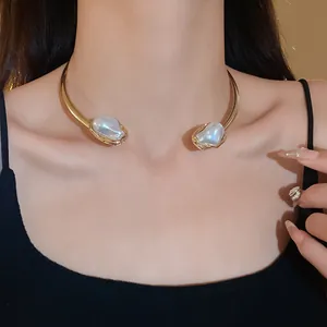 Close-up view of a French vintage style gold choker featuring irregular faux pearls