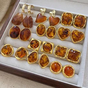 Vintage coffee-tone heart and oval resin earrings set in a jewelry display box