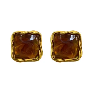 Elegant vintage gold-framed square stud earrings with amber brown marble resin inlay