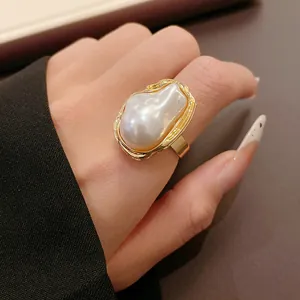 Detailed view of a French retro gold ring featuring a large irregular baroque faux pearl