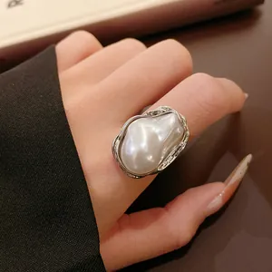 Detailed view of French vintage ring with large irregular faux pearl and textured silver band