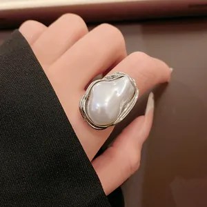 Detailed view of irregular baroque faux pearl ring featuring silver-toned crumpled texture