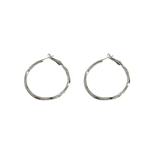 Pair of minimalist silver-toned twisted hoop earrings with a glossy metallic finish