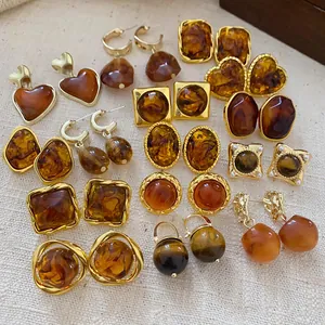 Detailed macro view of vintage brown geometric resin earrings with heart and oval shapes