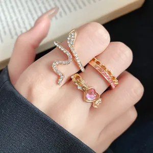 Close-up of French vintage heart and snake ring set with pink crystals