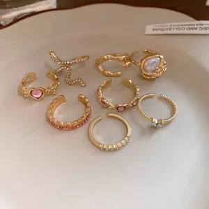 Detailed view of 8pcs vintage gold ring set with rhinestone heart and snake designs