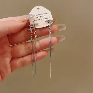 Close-up of elegant silver tassel earrings with shimmering star-shaped rhinestones