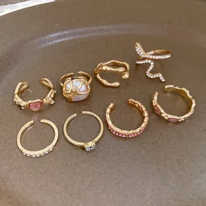 Detail view of 8-piece vintage French gold ring set with heart and pearl accents