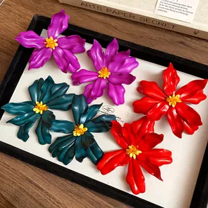 Macro view of oversized colorful acrylic flower stud earrings with bead centers
