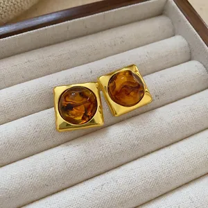 Detailed view of vintage Maillard brown square stud earrings in a velvet tray