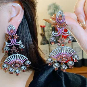 Detailed view of ornate vintage court style pink zircon fan drop earrings with silver pins