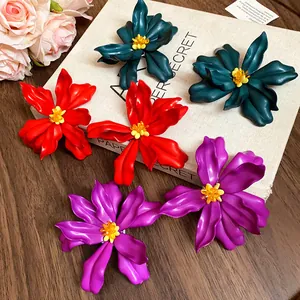 Detailed view of oversized acrylic flower earrings with seed bead centers in three colors
