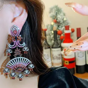 Close-up of retro palace style fan-shaped earrings with pink zircons and silver needles