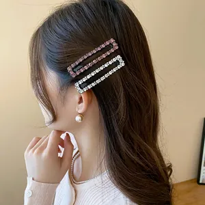 Close-up of elegant sparkling rhinestone rectangular hair clips worn by an Asian model
