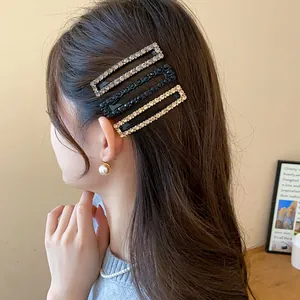 Close-up of elegant rectangular rhinestone hair clips worn on side hair of a model