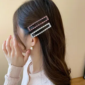 Detailed view of elegant square rhinestone hair clips worn on the side by an Asian model