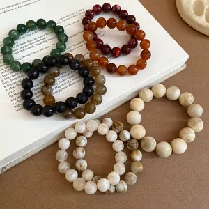 Close-up of smudge-painted beaded bracelets with marble texture