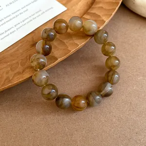 Detail of vintage swirled resin bead bracelet with earthy marble pattern and glossy finish