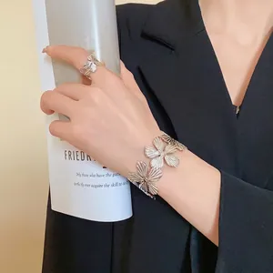 Elegant silver textured metal flower open bangle bracelet and matching ring set for women