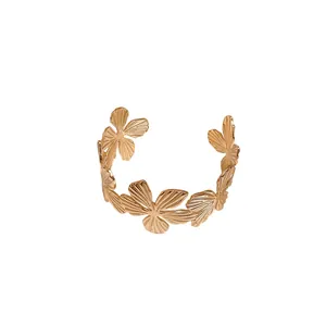 Elegant gold-tone open cuff bracelet featuring textured floral motifs for women, chic