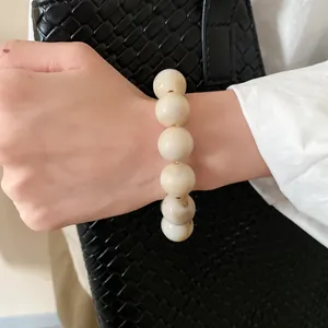Detail view of a chic vintage marbled beaded bracelet worn elegantly on a wrist