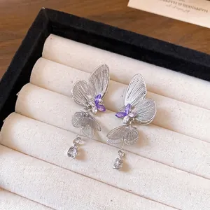Silver needle hollow butterfly earrings with purple rhinestones and water drop tassels