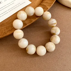 Close-up of elegant marble pattern beaded bracelet with a warm vintage aesthetic style
