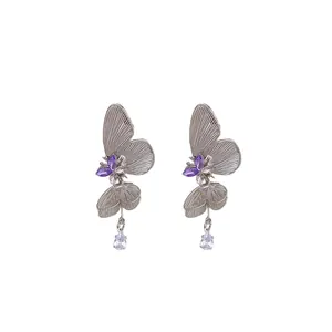 Elegant silver butterfly earrings with purple crystals and clear water drop tassels.