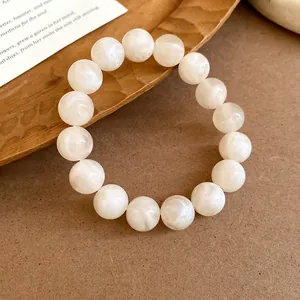 Close-up of white marble beaded bracelet with swirled patterns and elegant texture