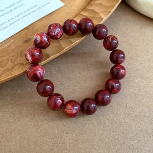 Macro view showing the intricate red marbled texture of this vintage beaded bracelet