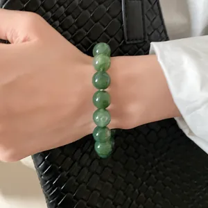 Detailed view of an elegant green marbled beaded bracelet for women in retro minimalist style
