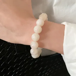 Detailed view of minimalist cream beaded bracelet with elegant marble texture on wrist