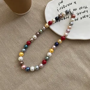 Detailed view of a vibrant multicolored pearl necklace on a rustic table setting