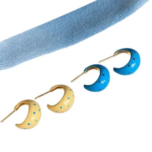 Stylish polka dot C-shaped enamel hoop earrings in vibrant blue and cream yellow colors