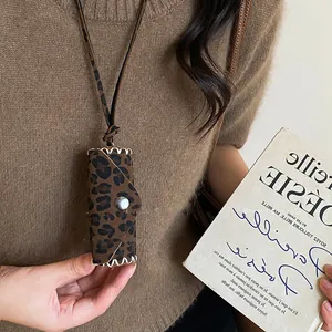 Detailed view of leopard print leather pouch pendant necklace with retro Maillard style.