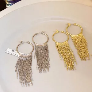 Elegant gold and silver plated hoop earrings featuring long dense metallic fringe tassels