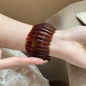 Detailed close-up showing the tortoiseshell resin texture of this oval cuff bangle bracelet