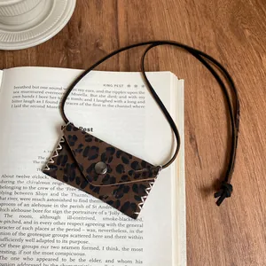 Close-up of retro Maillard style leopard print leather mini pouch pendant necklace